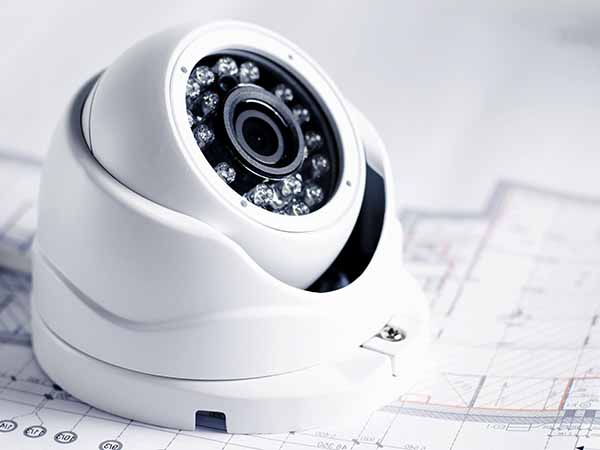 Video security equipment and blueprint on a table. Good for security service engineering company site or advertising Impianti-di-sicurezza-modena